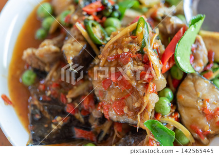 Spicy Thai catfish stir fry eggplant red chili pea eggplant bamboo shoots aromatic herbs served savory sauce Spicy Thai catfish stir fry eggplant red chili pea eggplant bamboo shoots aromatic herbs served savory sauce 142565445