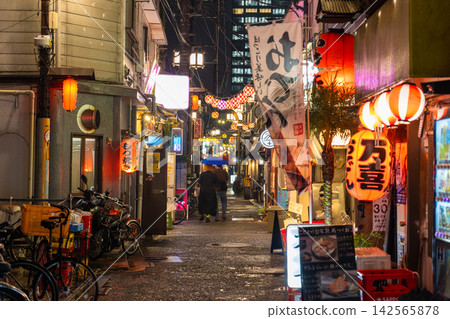 The nostalgic bar district and alleys in front of Nakano Station shine on a rainy night. The nostalgic bar district and alleys in front of Nakano Station shine on a rainy night. 142565878