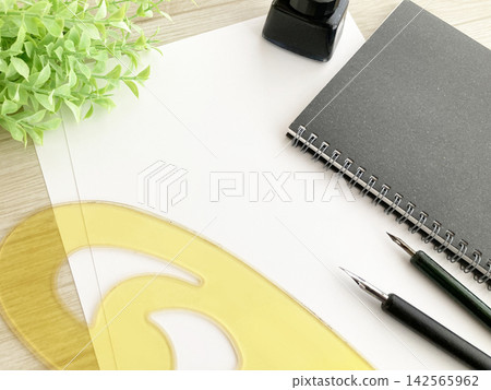Manga production, calligraphy, drawing work, French curve ruler and dip pen, black notebook, ink Manga production, calligraphy, drawing work, French curve ruler and dip pen, black notebook, ink 142565962