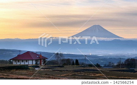 Mount Fuji bathed in the morning sun and the tranquil rural landscape of Hokuto City, Yamanashi Prefecture. 142566254