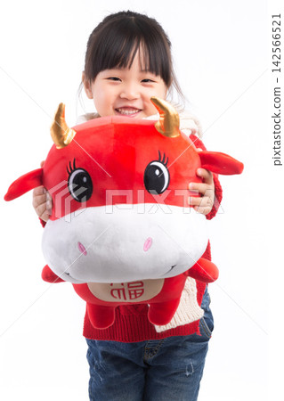 Smiling little girl hugging a red ox plush toy, celebrating the Year of the Ox, Chinese New Year theme.The Chinese character embroidered above: "Fu" (Good Fortune) 142566521