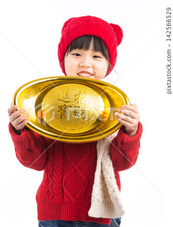 Happy Asian girl holding a large gold ingot (Yuanbao) wishing for wealth and prosperity in Chinese New Year.The Chinese characters above: "Attract Wealth and Treasure" 142566529
