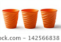 Three bright orange plastic cups isolated on a white background 142566838