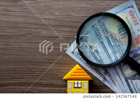 House model, money and magnifying glass for real estate investment House model, money and magnifying glass for real estate investment 142567148