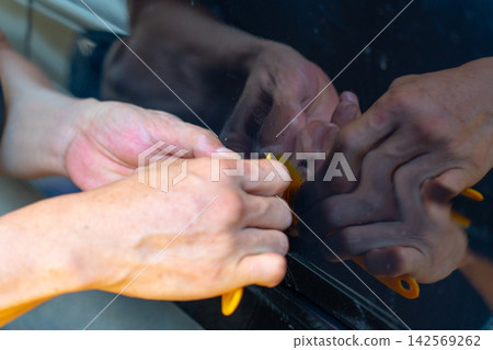 Removing dents on the car. PDR technology. Car body repair without painting. 142569262