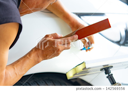 Removing dents on the car. PDR technology. Car body repair without painting. Removing dents on the car. PDR technology. Car body repair without painting. 142569356