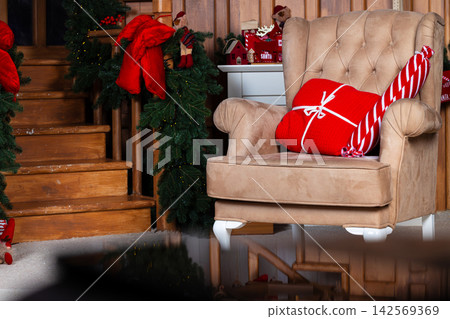 Cozy Christmas cottage interior with festive decorations and gifts ready for holidays Cozy Christmas cottage interior with festive decorations and gifts ready for holidays 142569369