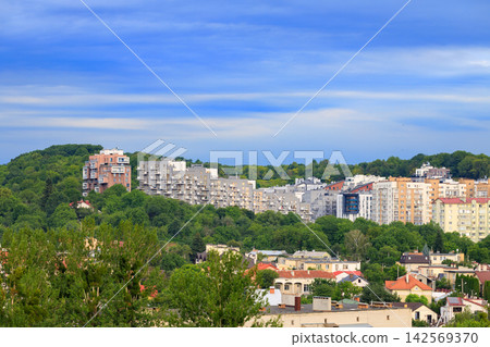 Modern concrete apartment buildings nestled on green hills outside an Eastern European city Modern concrete apartment buildings nestled on green hills outside an Eastern European city 142569370