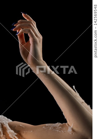 Elegant hand reaching out against a dark background in a dramatic pose Elegant hand reaching out against a dark background in a dramatic pose 142569548