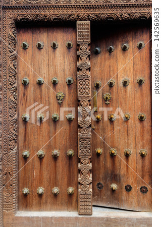 Traditional wooden carved door in Stone Town, Zanzibar, Tanzania Traditional wooden carved door in Stone Town, Zanzibar, Tanzania 142569635
