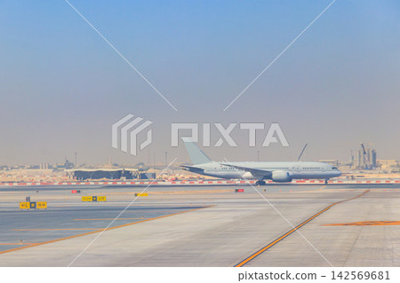 Airplane on runway in Doha airport, Qatar Airplane on runway in Doha airport, Qatar 142569681