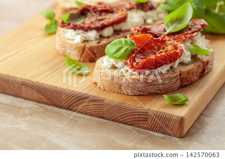Ciabatta with sun dried tomatoes in olive oil, ricotta, and basil. Ciabatta with sun dried tomatoes in olive oil, ricotta, and basil. 142570063