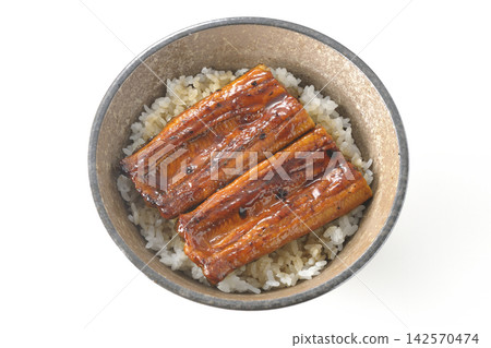 A single serving of eel rice bowl photographed against a white background. A single serving of eel rice bowl photographed against a white background. 142570474
