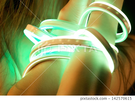 Alluring nude woman with neon straps on hands Alluring nude woman with neon straps on hands 142570615