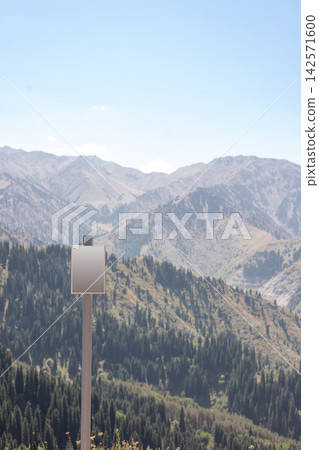 Blank information sign against mountain landscape in clear daylight with copy space for text Blank information sign against mountain landscape in clear daylight with copy space for text 142571600