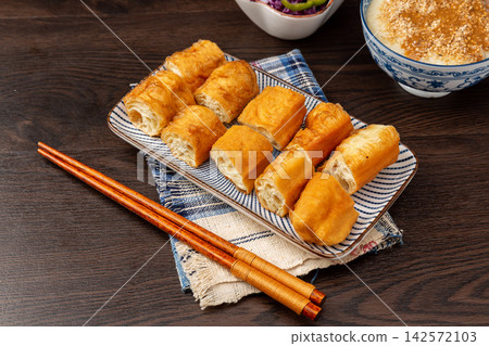 sliced Pieces of Traditional Chinese Fried Dough Sticks Youtiao for Breakfast Serving sliced Pieces of Traditional Chinese Fried Dough Sticks Youtiao for Breakfast Serving 142572103