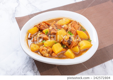 braised chicken chunks with potatoes in rich savory soy sauce braised chicken chunks with potatoes in rich savory soy sauce 142572804