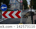 Road construction and traffic diversion with temporary traffic lights and roadworks barriers 142573110