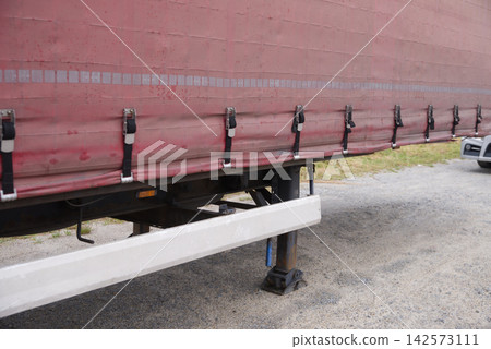 Semi-trailer truck parked near an industrial building Semi-trailer truck parked near an industrial building 142573111