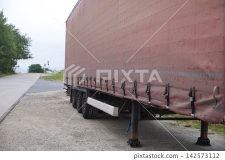 Semi-trailer truck parked near an industrial building Semi-trailer truck parked near an industrial building 142573112
