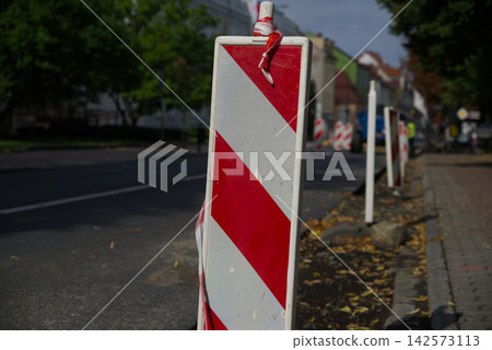 Road construction and traffic diversion with temporary traffic lights and roadworks barriers Road construction and traffic diversion with temporary traffic lights and roadworks barriers 142573113
