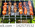 colorful shish kebabs on steel skewers on mangal 142573532