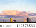 pink cloud in blue sunset sky over modern building 142573533