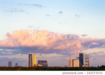 pink cloud in blue sunset sky over modern building pink cloud in blue sunset sky over modern building 142573533