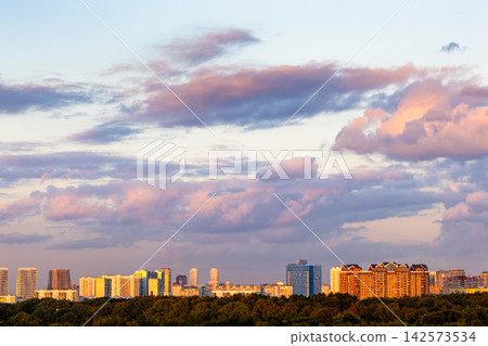 dark pink clouds in blue sunset sky over city dark pink clouds in blue sunset sky over city 142573534