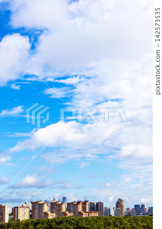 blue sky with large white cloud over city district blue sky with large white cloud over city district 142573535
