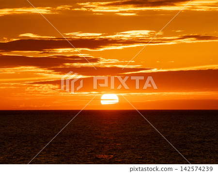 Sunset over the sea and orange sky Sunset over the sea and orange sky 142574239