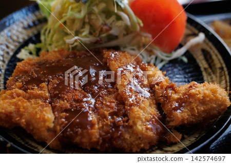 A hearty jumbo pork cutlet set meal at a cafeteria near the university. A hearty jumbo pork cutlet set meal at a cafeteria near the university. 142574697