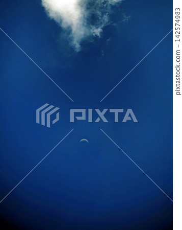 A white moon floating in the blue sky A white moon floating in the blue sky 142574983