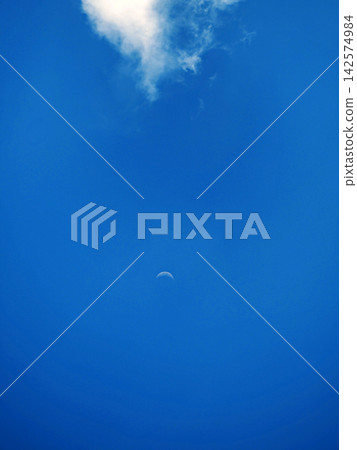 A white moon floating in the blue sky A white moon floating in the blue sky 142574984