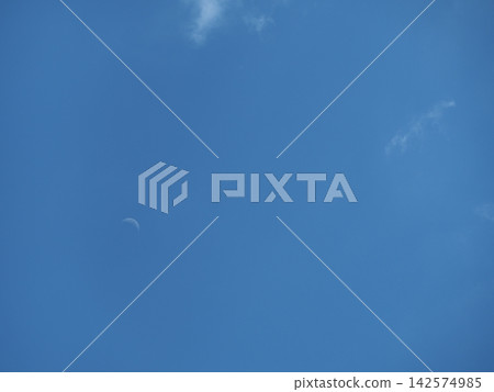 A white moon floating in the blue sky A white moon floating in the blue sky 142574985