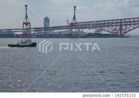 A red bridge connecting a ship and a harbor A red bridge connecting a ship and a harbor 142575133