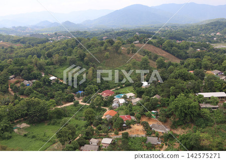 Aerial View of Rural Mountain Village Surrounded by Green Hills Aerial View of Rural Mountain Village Surrounded by Green Hills 142575271