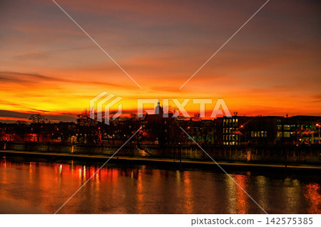 Colorful bright sunset over Vistula river in Krakow, Poland Colorful bright sunset over Vistula river in Krakow, Poland 142575385
