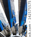 A modern monumental building featuring mirrored panels and blue sculptures. 142575575