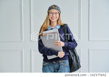 Smiling teenage student girl with backpack and laptop Smiling teenage student girl with backpack and laptop 142575642