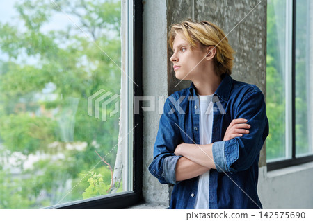 Thoughtful teenage student with crossed arms indoor Thoughtful teenage student with crossed arms indoor 142575690