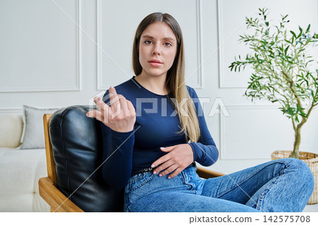 Web cam view of young woman talking looking in camera, online meeting, video call Web cam view of young woman talking looking in camera, online meeting, video call 142575708