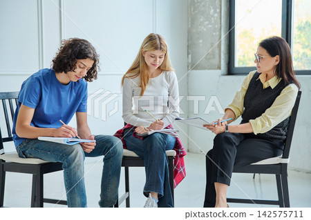 Teenagers at a group therapy session with psychologist Teenagers at a group therapy session with psychologist 142575711