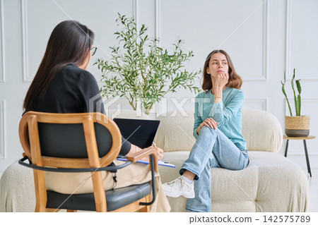Thoughtful teenage girl at psychologist appointment Thoughtful teenage girl at psychologist appointment 142575789