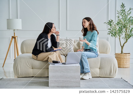 Psychologist consulting young female patient in office Psychologist consulting young female patient in office 142575829