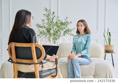 Social worker listening to teenage girl in the office Social worker listening to teenage girl in the office 142575836