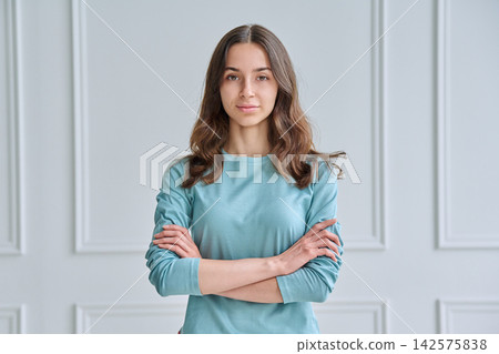 Confident teen girl with crossed arms in mint top Confident teen girl with crossed arms in mint top 142575838