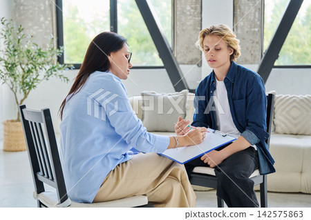 Teenager student talking to counselor in the office 142575863