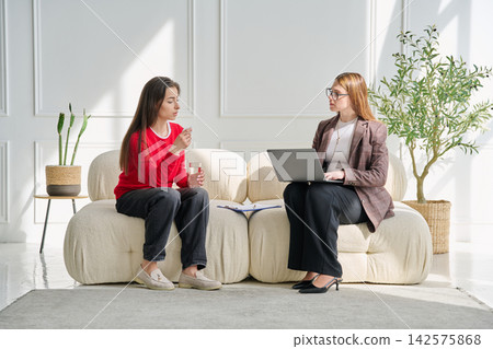 Sad teenage female patient in therapy session in psychologist office Sad teenage female patient in therapy session in psychologist office 142575868