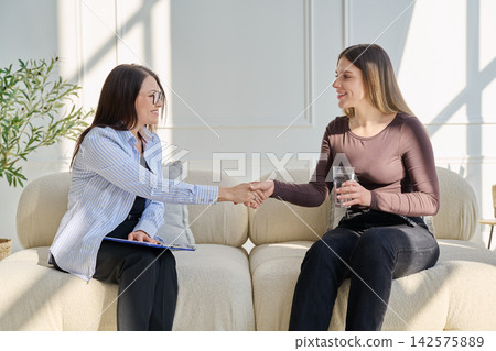 Young woman in therapy session talking with psychotherapist Young woman in therapy session talking with psychotherapist 142575889